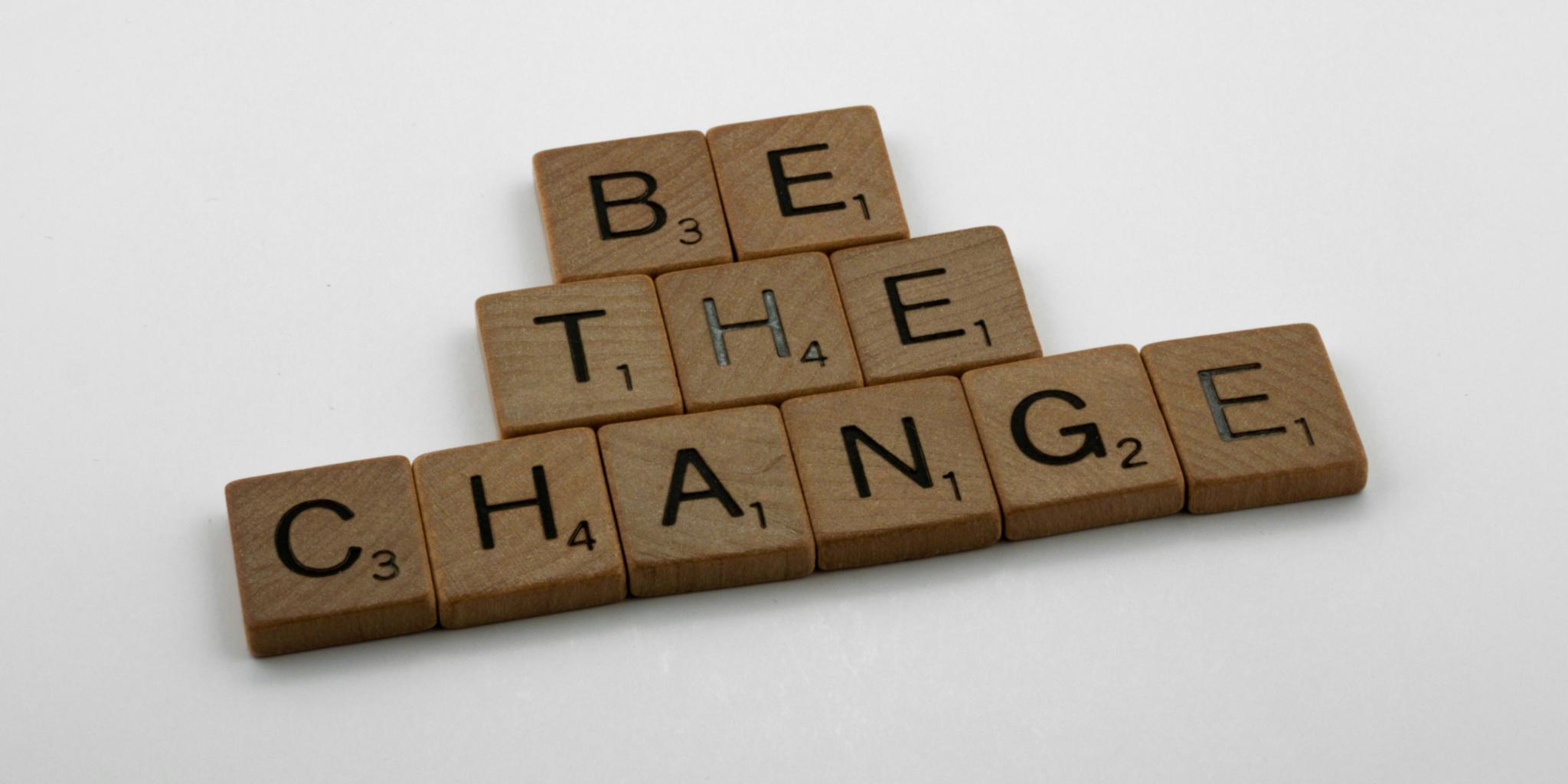 Schriftzug mit Scabble-Buchstaben, der 'Sei die Veränderung' zeigt