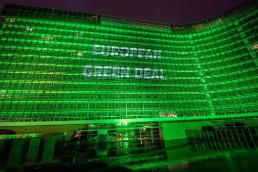Das Berlaymont-Gebäude, Sitz der Europäischen Kommission, Nachtaufnahme, grün illuminiert mit dem Schriftzug 'European Green Deal'