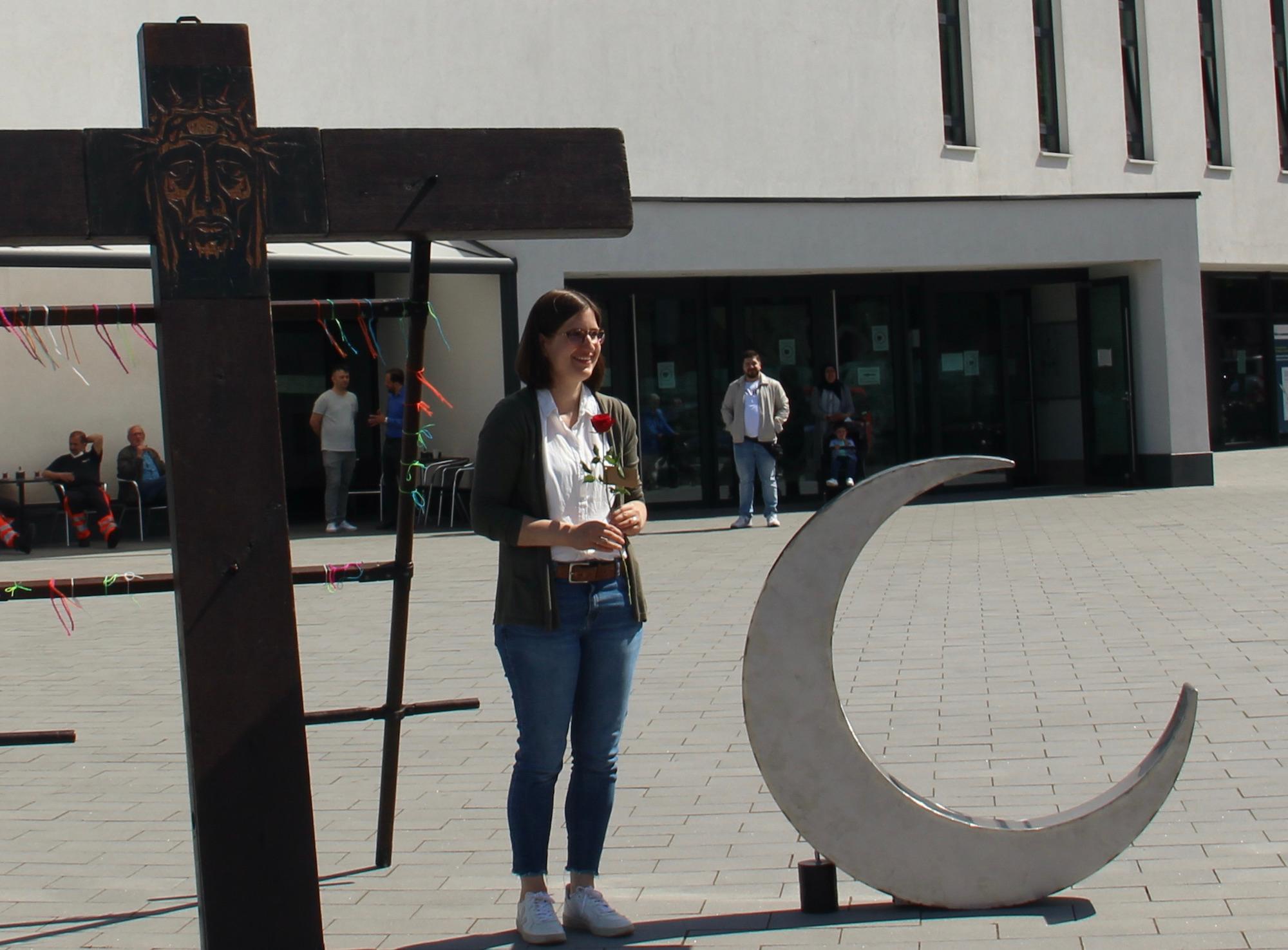 Starkes Symbol: Friedenskreuz und Halbmond vor der Moschee. Dazwischen Yasmin Raimundo-Ochoa.